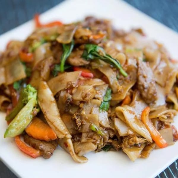 Omaha Mercy Thai's Pad See Ew with wide noodles, beef, broccoli, carrots, and bell peppers.