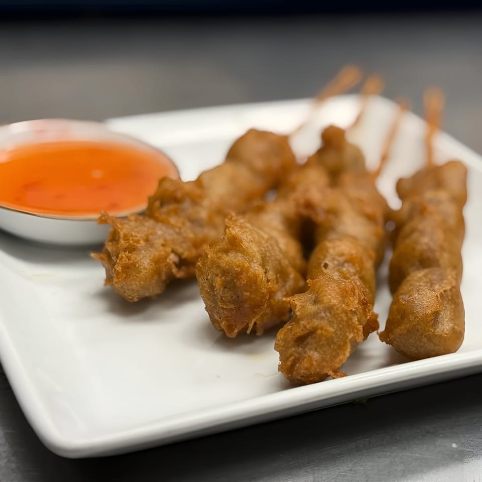 Four crispy fried skewers of Thai chicken or pork, served with a side of sweet chili dipping sauce.