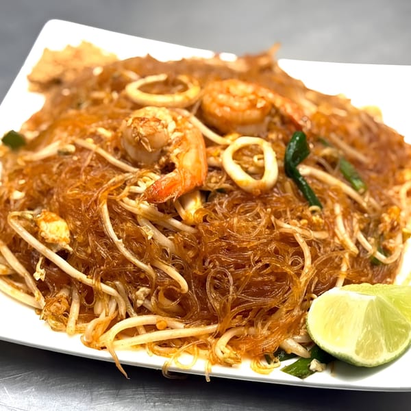 Omaha Mercy Thai's Pad Woon Sen with shrimp, squid, bean sprouts, and lime wedges.