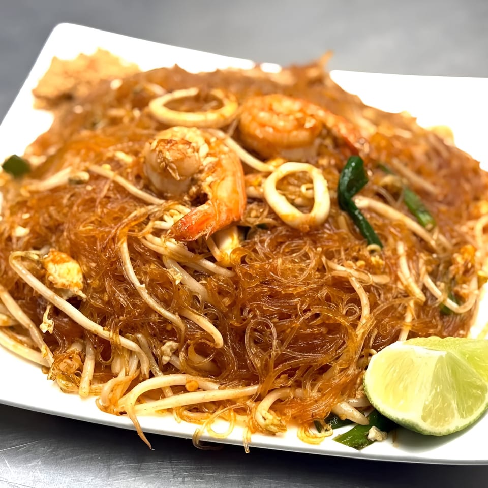 Omaha Mercy Thai's Pad Woon Sen with shrimp, squid, bean sprouts, and lime wedges.