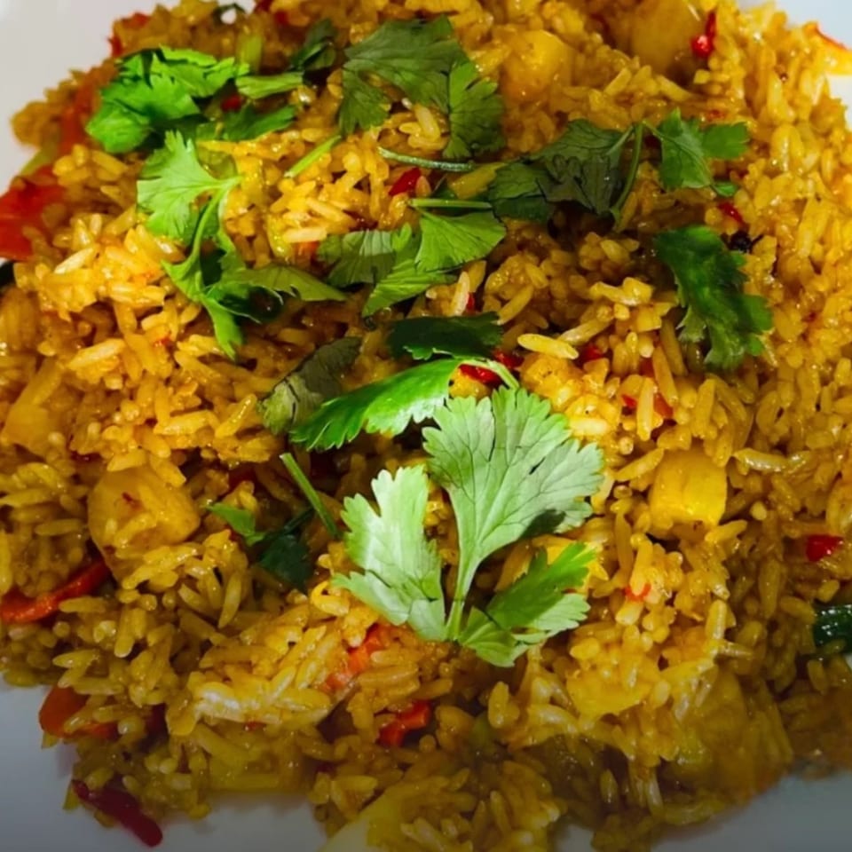 Close-up of Omaha Mercy Thai's pineapple fried rice, garnished with fresh cilantro.