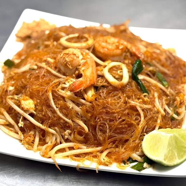 Omaha Mercy Thai's Pad Woon Sen with shrimp, squid, bean sprouts, and lime wedges.