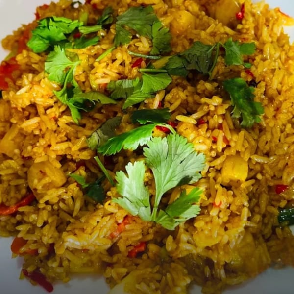 Close-up of Omaha Mercy Thai's pineapple fried rice, garnished with fresh cilantro.